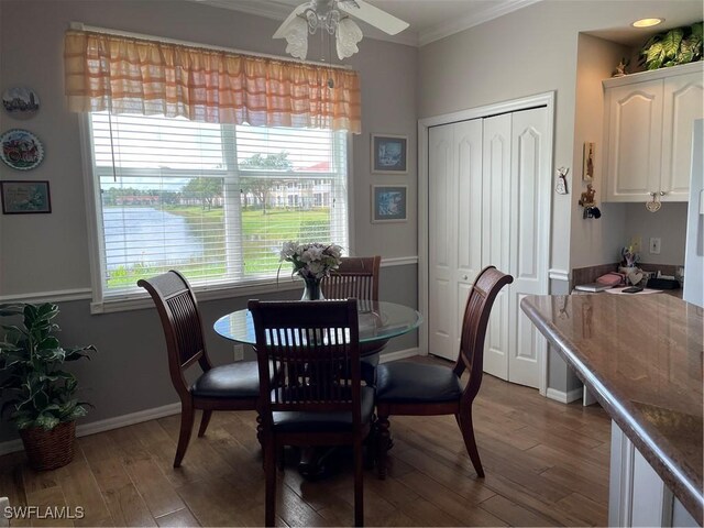 dining room featuring wood-type flooring, ornamental molding, and ceiling fan