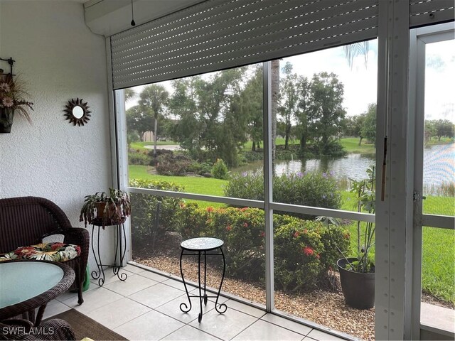 sunroom / solarium with a water view