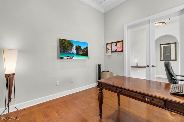 home office featuring hardwood / wood-style floors, french doors, and crown molding