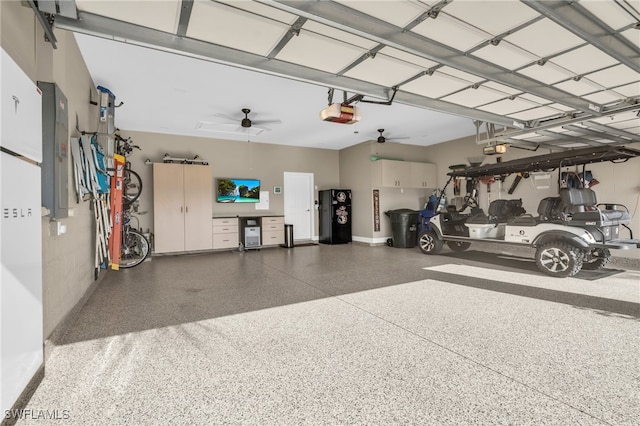 garage with a garage door opener, electric panel, water heater, and ceiling fan