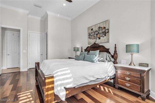 bedroom with hardwood / wood-style floors and crown molding