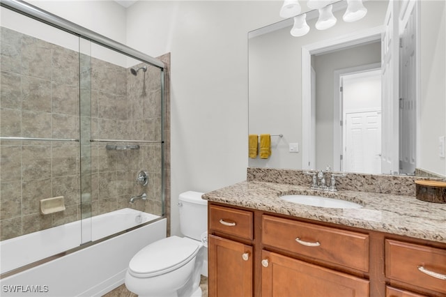 full bathroom with toilet, combined bath / shower with glass door, and vanity