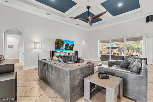 living room featuring light tile patterned flooring, ceiling fan, crown molding, and coffered ceiling