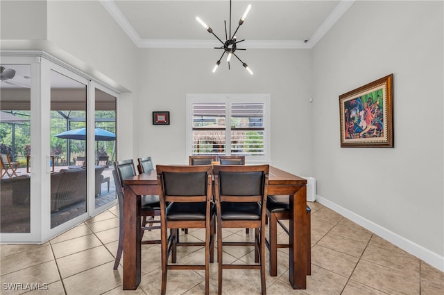 dining area featuring light tile patterned flooring, ornamental molding, and a notable chandelier