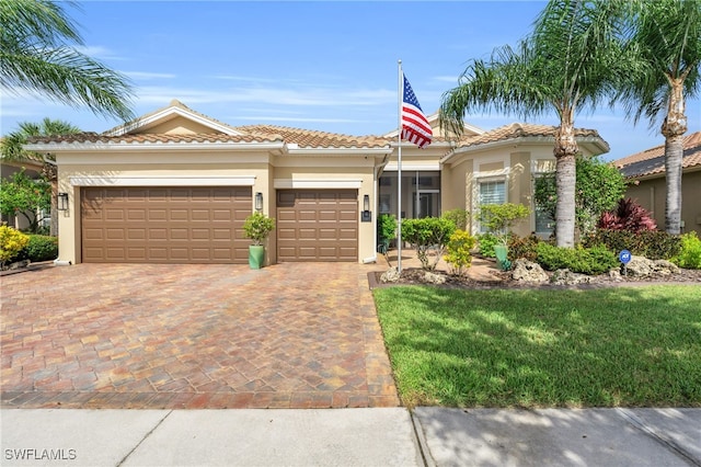 mediterranean / spanish house featuring a front lawn and a garage