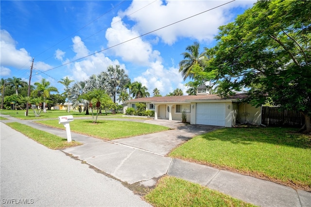 view of front of property featuring a garage and a front yard