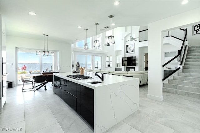 kitchen with dark cabinets, plenty of natural light, a sink, and modern cabinets