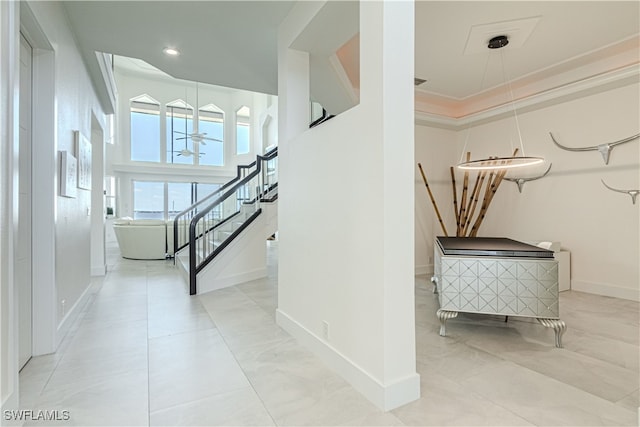 interior space featuring stairs, recessed lighting, a towering ceiling, and baseboards