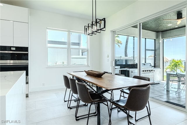 dining area featuring light tile patterned floors and baseboards