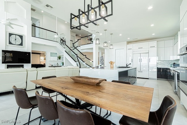 dining space with stairs, light tile patterned floors, visible vents, and recessed lighting