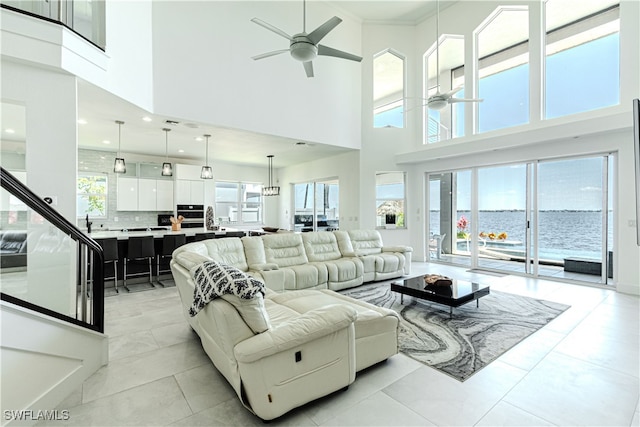 living area featuring a ceiling fan and light tile patterned flooring