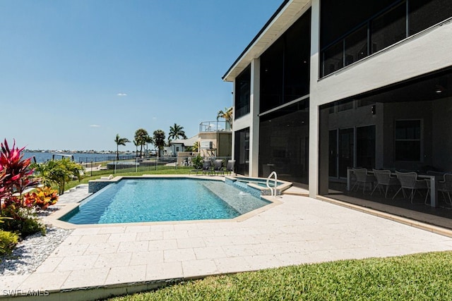 view of swimming pool featuring a sunroom, a patio area, fence, and a pool with connected hot tub