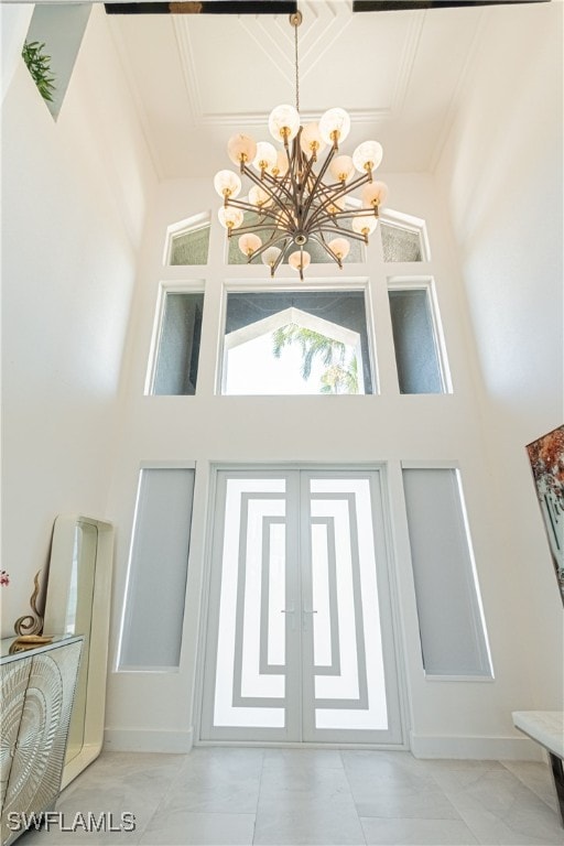 details featuring french doors and a notable chandelier