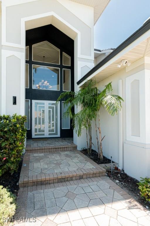 property entrance with french doors and stucco siding