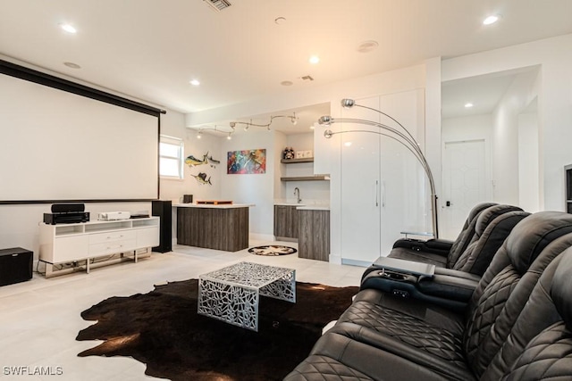 cinema featuring wet bar, visible vents, a sink, and recessed lighting