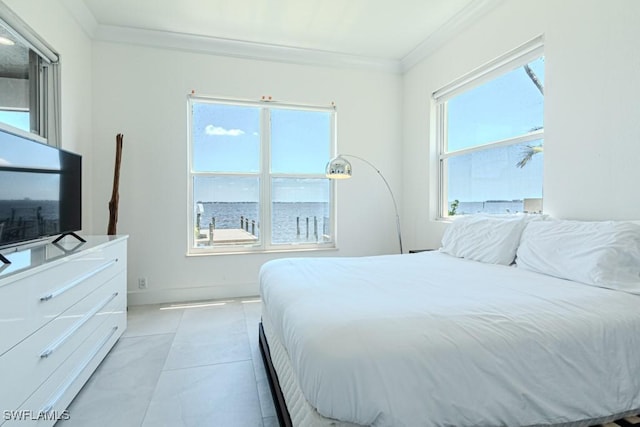 bedroom with ornamental molding, light tile patterned flooring, and baseboards