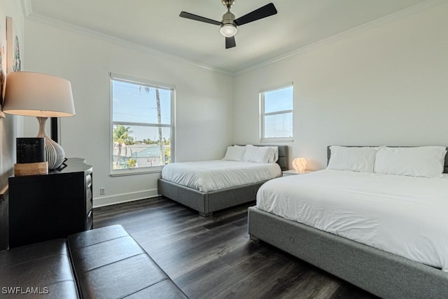 bedroom featuring dark wood-style floors, multiple windows, and crown molding