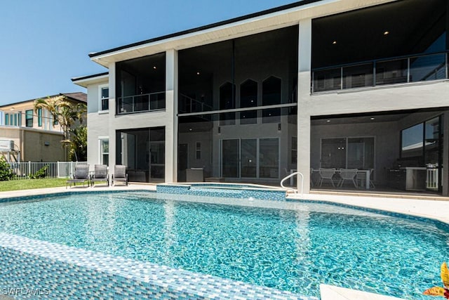 view of pool with a patio, a jacuzzi, fence, a sunroom, and a fenced in pool