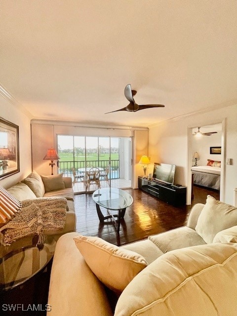 living room with crown molding, ceiling fan, and wood-type flooring