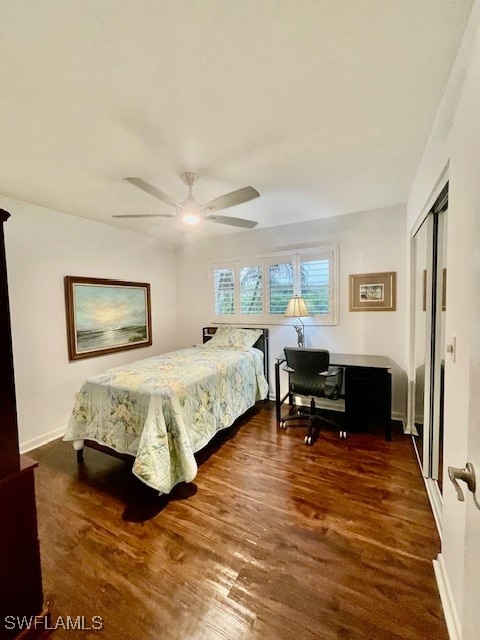 bedroom with ceiling fan, dark hardwood / wood-style floors, and a closet