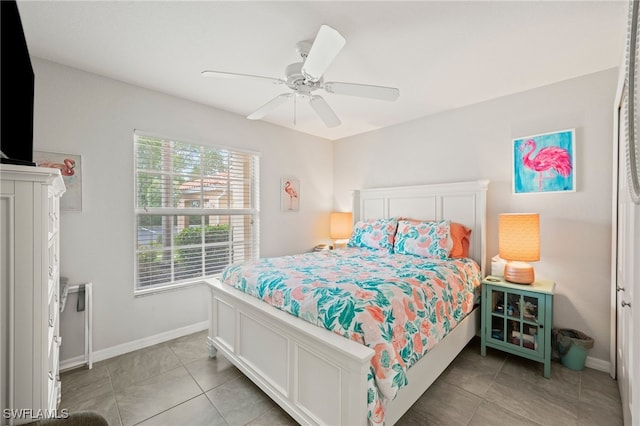 tiled bedroom featuring ceiling fan