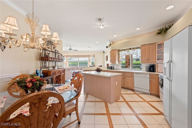 kitchen with light brown cabinetry, a center island, crown molding, white appliances, and ceiling fan