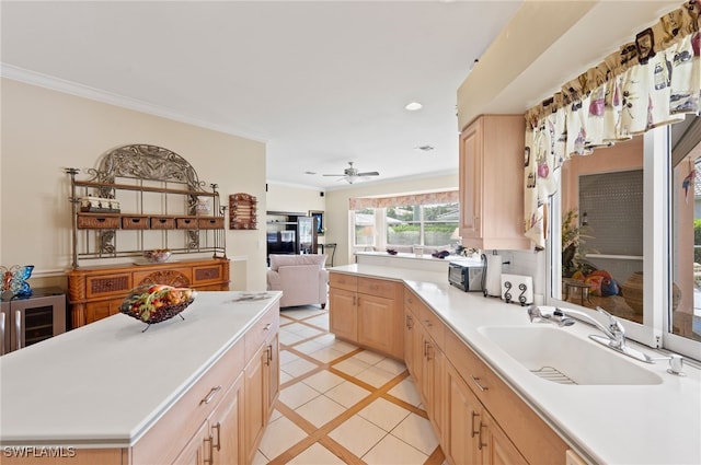 kitchen featuring light brown cabinetry, sink, light tile patterned flooring, ceiling fan, and a kitchen island