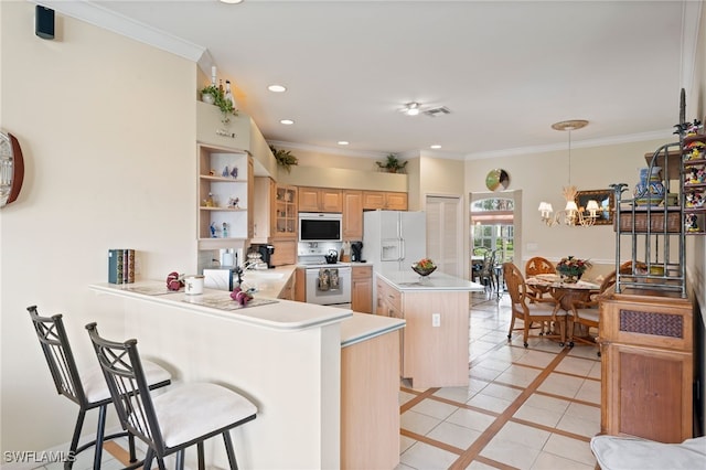 kitchen featuring white appliances, pendant lighting, a notable chandelier, crown molding, and kitchen peninsula