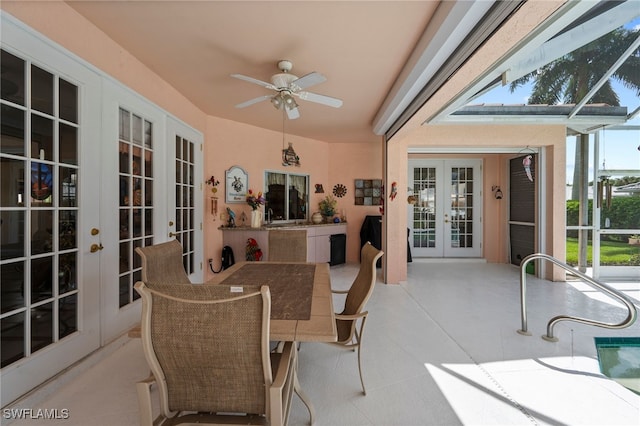 sunroom featuring ceiling fan, sink, and french doors