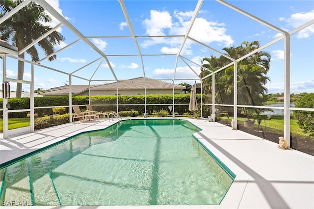 view of swimming pool with glass enclosure and a patio area