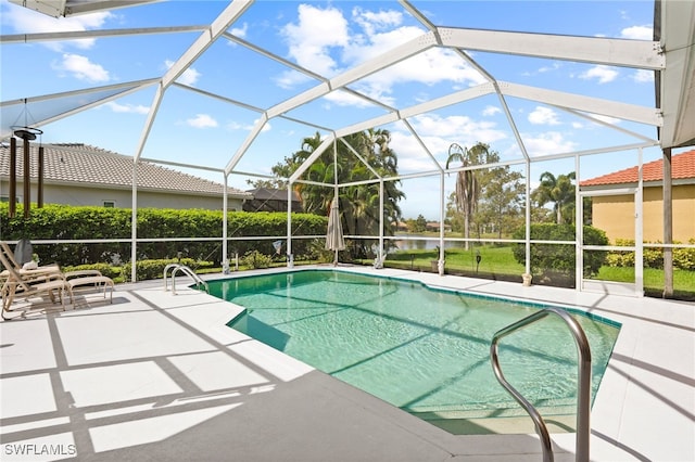 view of swimming pool with a lanai and a patio area