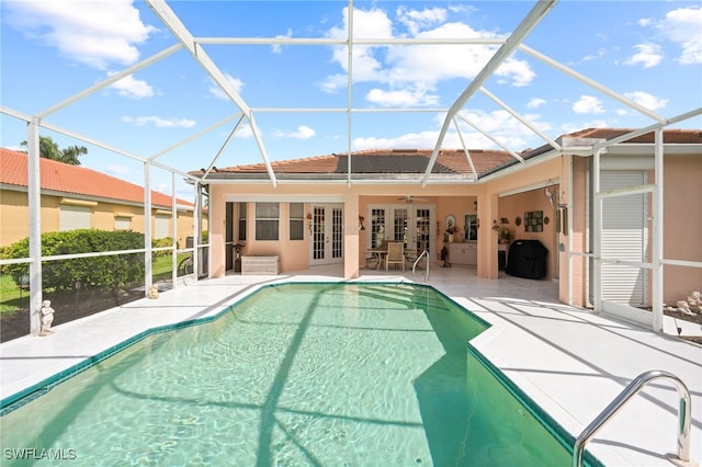 view of pool with a lanai, french doors, ceiling fan, and a patio