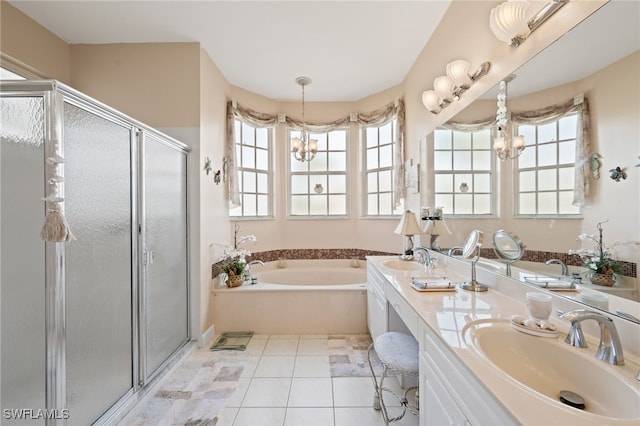 bathroom with tile patterned floors, independent shower and bath, a chandelier, and vanity