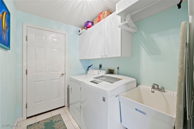 laundry room with separate washer and dryer, cabinets, sink, and light tile patterned flooring