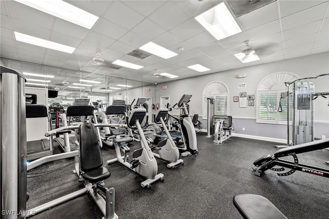 exercise room featuring a paneled ceiling and ceiling fan