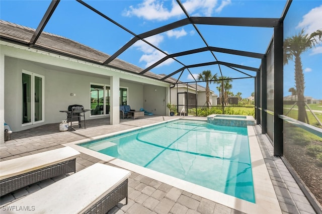 view of swimming pool featuring a grill, an in ground hot tub, a lanai, and a patio area