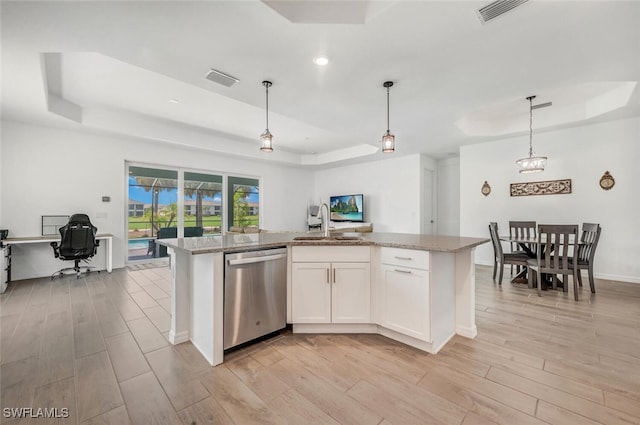 kitchen with light wood-type flooring, stainless steel dishwasher, and white cabinetry