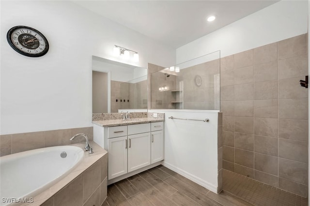 bathroom with independent shower and bath and vanity