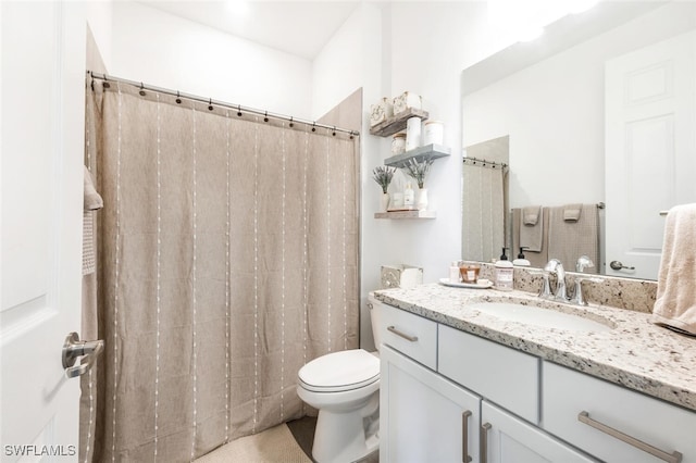 bathroom featuring walk in shower, vanity, and toilet