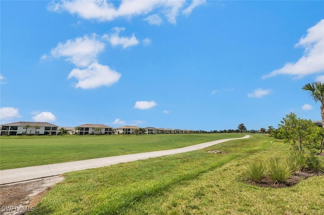 view of property's community with a lawn