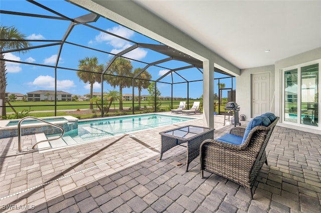 view of pool featuring glass enclosure, a jacuzzi, and a patio area