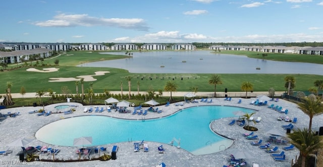 view of swimming pool featuring a water view and a patio area