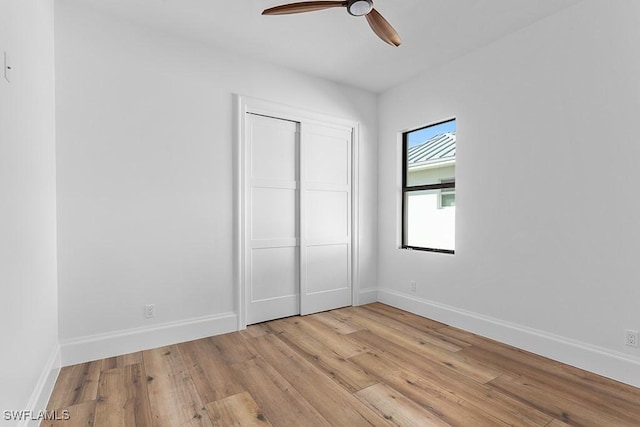 unfurnished bedroom featuring a closet, ceiling fan, and light hardwood / wood-style flooring