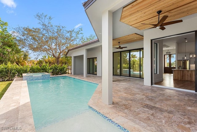 view of swimming pool featuring a patio area, an in ground hot tub, and ceiling fan