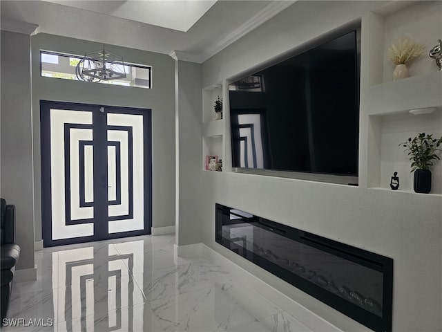 foyer entrance featuring ornamental molding and a chandelier