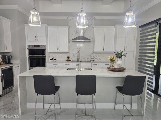 kitchen with ornamental molding, stainless steel double oven, beverage cooler, and a sink