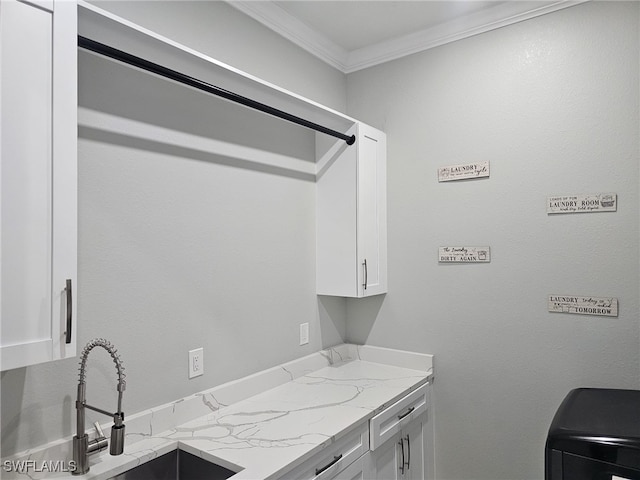 interior space featuring cabinets, ornamental molding, and sink