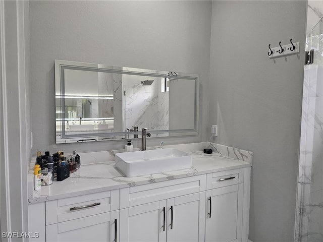 bathroom with vanity and a shower with shower door