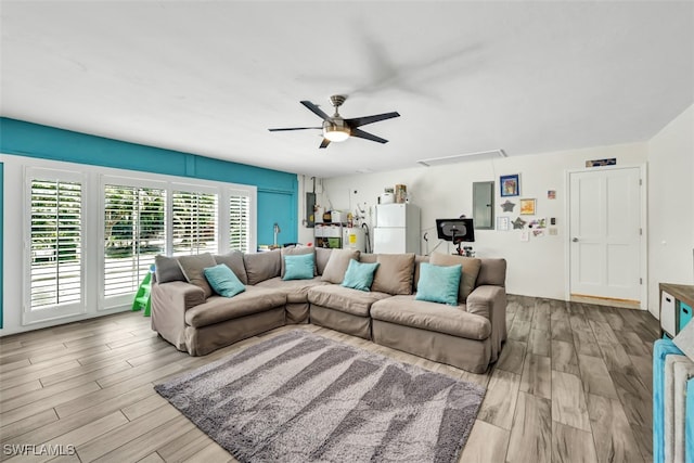 living room featuring light hardwood / wood-style flooring and ceiling fan