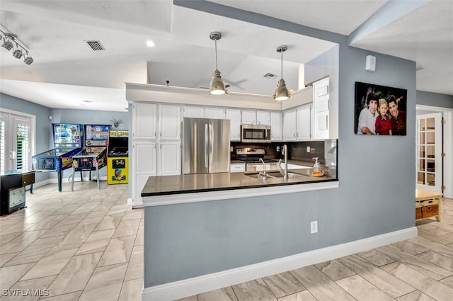 kitchen featuring appliances with stainless steel finishes, white cabinetry, sink, kitchen peninsula, and ceiling fan